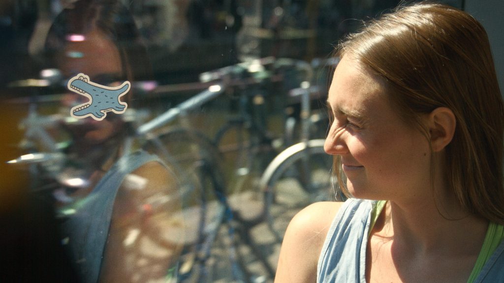 A girl with one eye closed playing the tram game